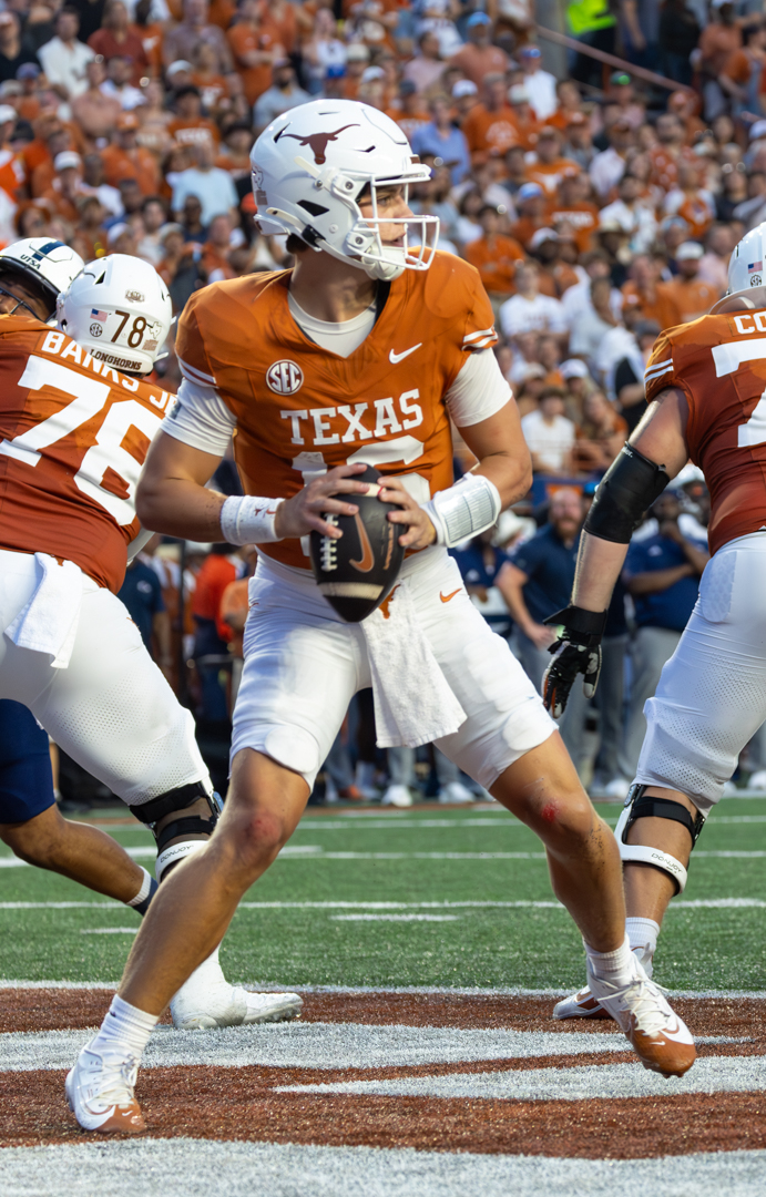 Arch Manning of the Texas Longhorns dropping back to pass at Darrell K Royal-Texas Memorial Stadium