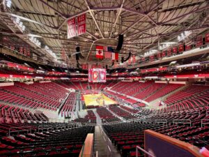An empty basketball arena with the court set up before a college game