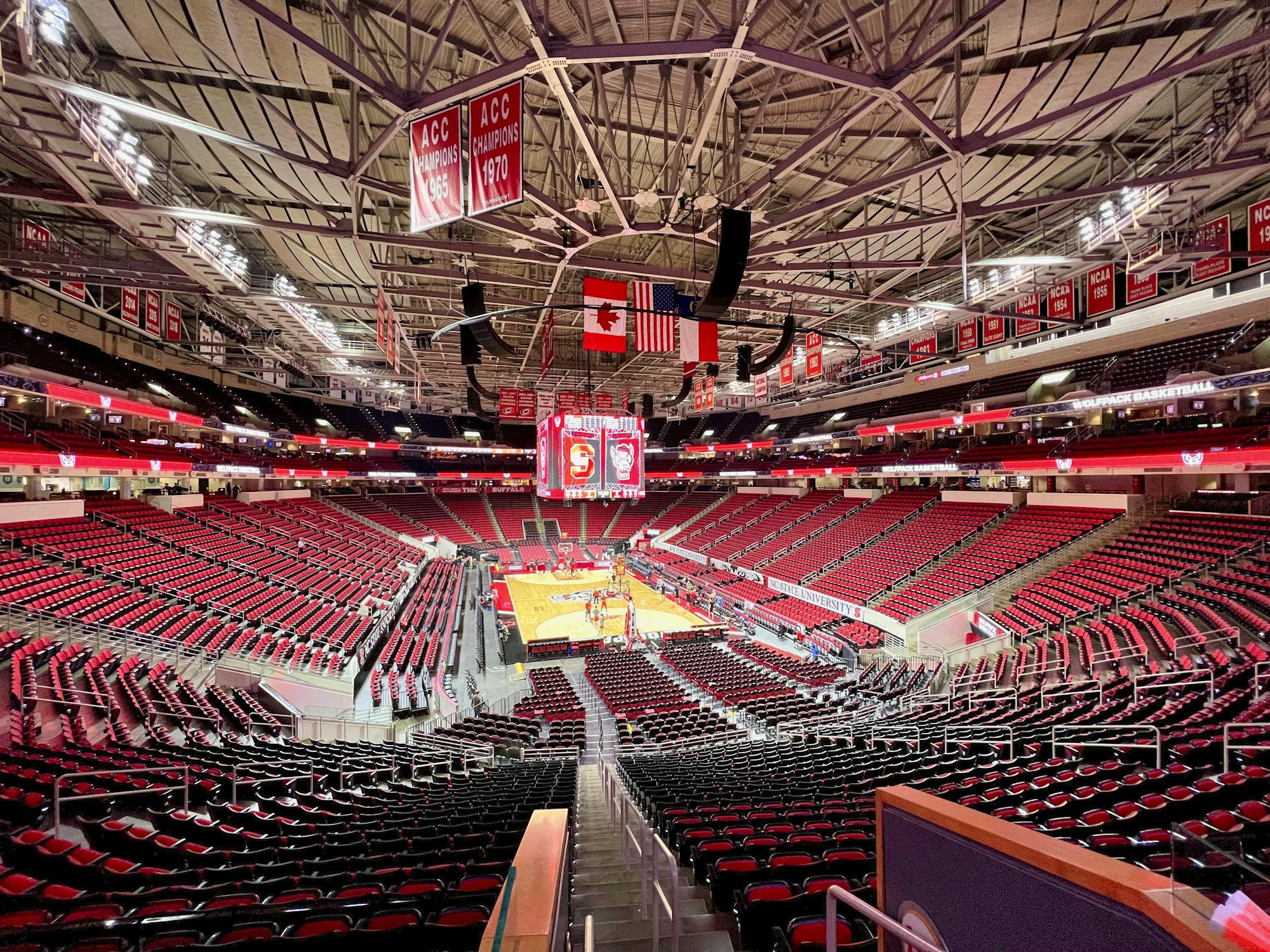 An empty basketball arena with the court set up before a college game