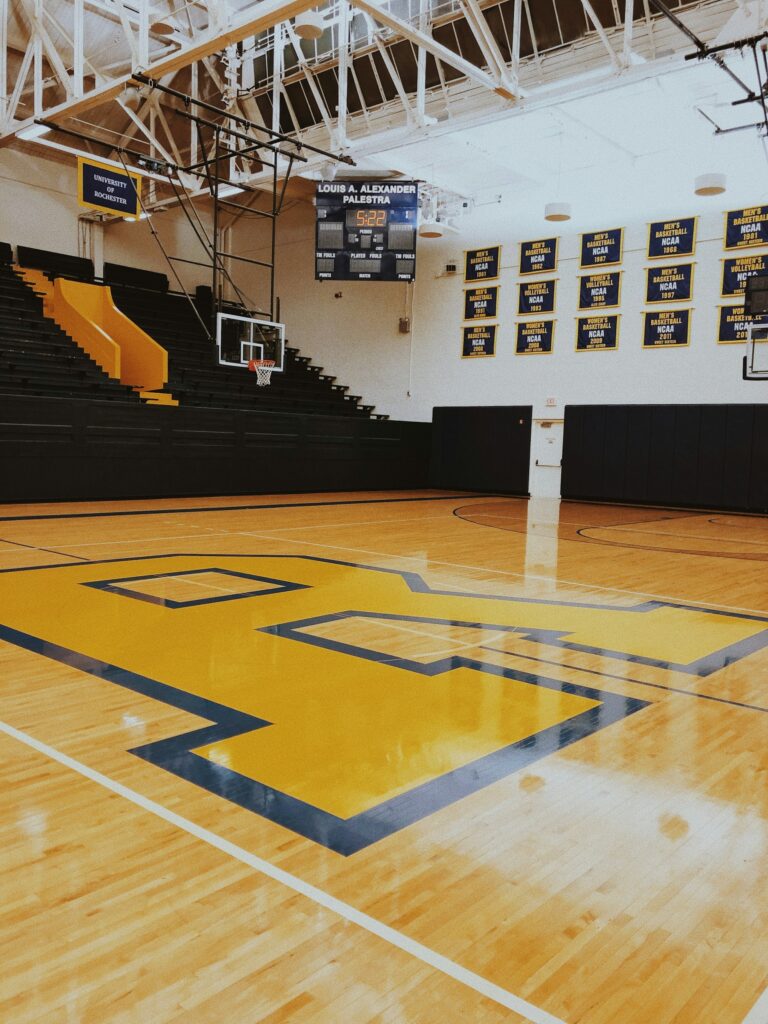 An empty college basketball court in a campus gym