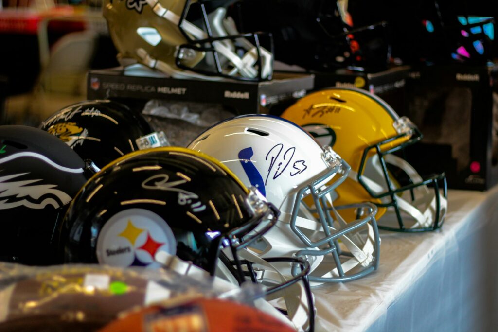 A row of football helmets lined up on a table